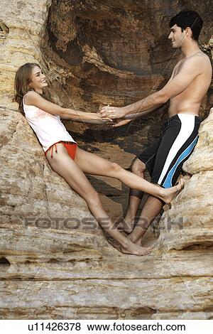 Young couple holding hands at cliff View Large Photo Image Stock Photo - Young couple holding hands at cliff. Fotosearch