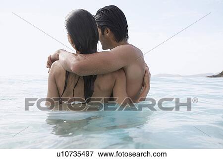Young couple hugging in water, St. John, US Virgin Islands, USA View Large Photo Image Stock Photo - Young couple hugging in water, St. John, US Virgin Islands, USA. Fotosearch