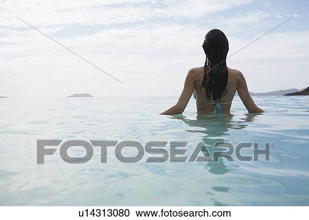 Young woman standing in water, St. John, US Virgin Islands, USA View Large Photo Image Stock Image - Young woman standing in water, St. John, US Virgin Islands, USA. Fotosearch