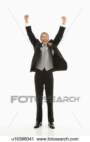 Stock Image - Caucasian groom with arms raised in air.. Fotosearch