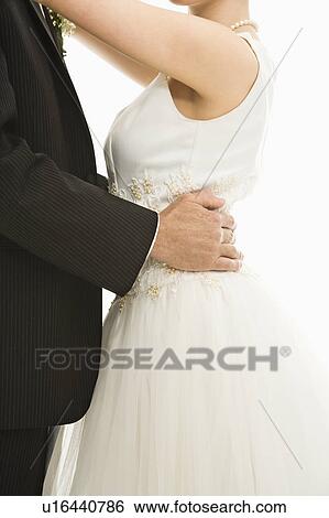 Stock Photograph - Close up of bride and groom dancing. Fotosearch