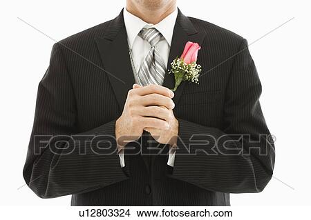 Picture - Close up of Caucasian groom with clenched fists.. Fotosearch