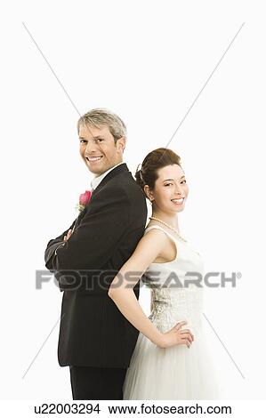 Groom and bride back to back View Large Photo Image Picture - Groom and bride back to back . Fotosearch