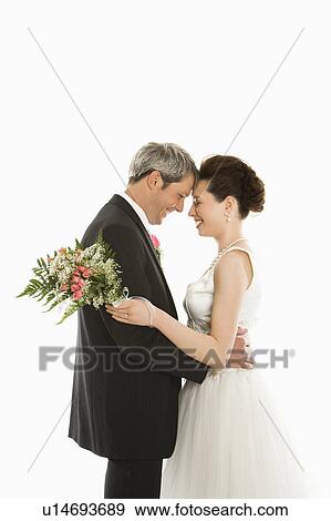 Stock Photo - Groom and bride embracing. Fotosearch
