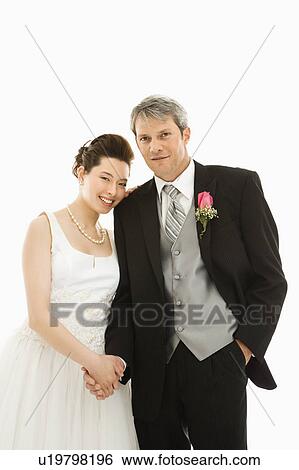 Stock Photograph - Groom and bride holding hands. Fotosearch