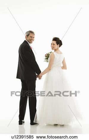 Groom and bride holding hands View Large Photo Image Stock Photography - Groom and bride holding hands. Fotosearch