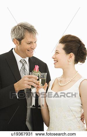 Groom and bride toasting with champagne glasses. View Large Photo Image Stock Image - Groom and bride toasting with champagne glasses.. Fotosearch