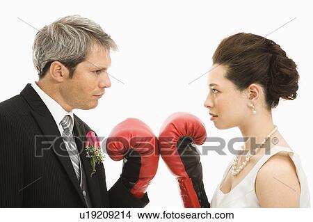 Groom and bride wearing boxing gloves View Large Photo Image Picture - Groom and bride wearing boxing gloves. Fotosearch