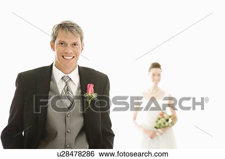 Groom in foreground and bride in background View Large Photo Image Stock Photograph - Groom in foreground and bride in background. Fotosearch