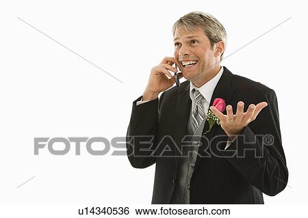 Groom talking on cellphone View Large Photo Image Stock Photograph - Groom talking on cellphone. Fotosearch