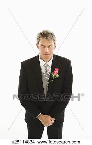 Picture - Groom with hands clasped in front of him. Fotosearch