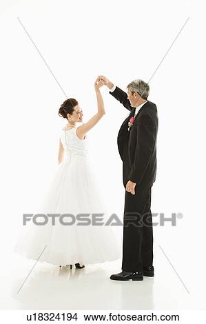 Portrait of Caucasian groom and Asian bride dancing. View Large Photo Image Picture - Portrait of Caucasian groom and Asian bride dancing.. Fotosearch