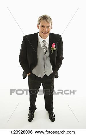 Stock Photograph - Portrait of Caucasian groom with hands in pockets.. Fotosearch
