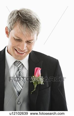 Stock Photo - Portrait of Caucasian male in tuxedo with boutonniere.. Fotosearch