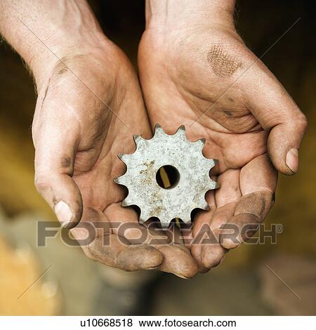 Dirty metal-smith's hands holding metal leaf View Large Photo Image Stock Photo - Dirty metal-smith's hands holding metal leaf. Fotosearch