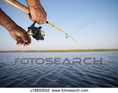 holding a fishing rod