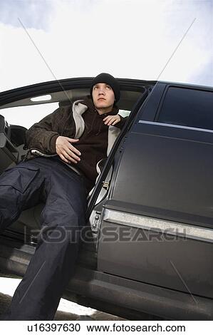 Male teenager sitting in SUV View Large Photo Image Stock Image - Male teenager sitting in SUV. Fotosearch