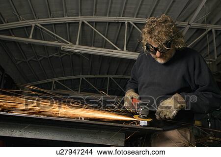 Metal-smith shaping metal and creating sparks View Large Photo Image Picture - Metal-smith shaping metal and creating sparks. Fotosearch