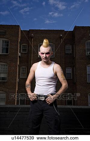 Stock Photo - Portrait of male punk outside building. Fotosearch