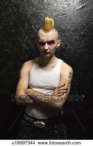 Picture - Portrait of mid-adult male punk with arms crossed. Fotosearch