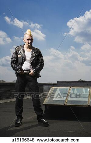 Portrait of mid-adult punk standing on roof View Large Photo Image Stock Photo - Portrait of mid-adult punk standing on roof. Fotosearch