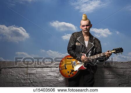 Stock Photograph - Punk holding guitar.. Fotosearch