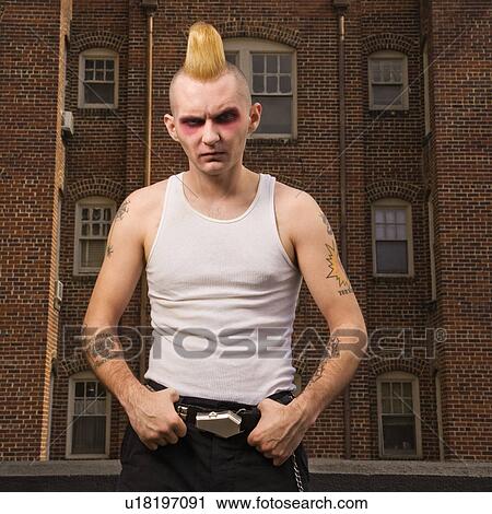 Stock Image - Punk outside with building in background. Fotosearch