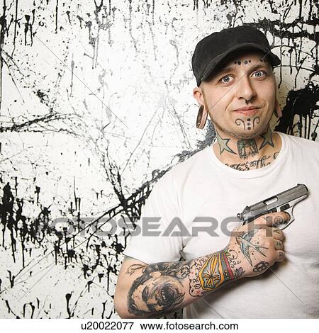 Tattooed man holding gun. View Large Photo Image Stock Photo - Tattooed man holding gun.. Fotosearch