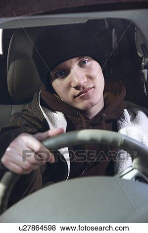 Stock Photo - Teenager behind the steering wheel. Fotosearch