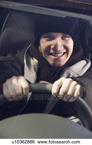 Teenager behind the steering wheel. View Large Photo Image Stock Photograph - Teenager behind the steering wheel.. Fotosearch