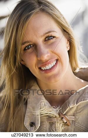 Attractive young adult woman with long hair smiling at viewer. View Large Photo Image Stock Image - Attractive young adult woman with long hair smiling at viewer.. Fotosearch