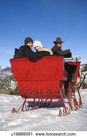 couple looking over shoulder from horse drawn sleigh View Large Photo Image Stock Image - couple looking over shoulder from horse drawn sleigh. Fotosearch
