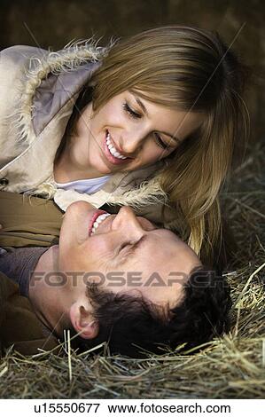 Couple lying in hay View Large Photo Image Stock Photo - Couple lying in hay. Fotosearch