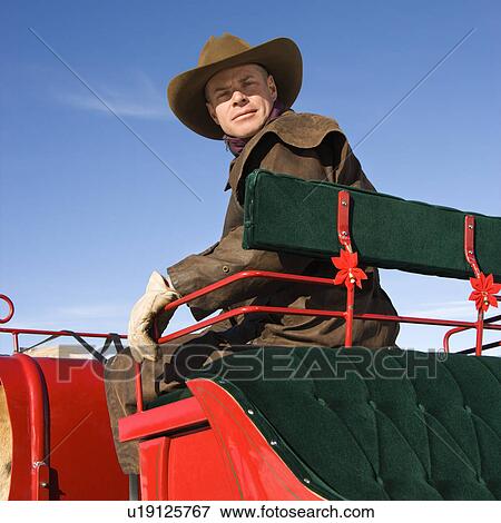 Man in sleigh looking at viewer View Large Photo Image Stock Photo - Man in sleigh looking at viewer. Fotosearch
