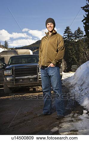 Stock Photo - Man standing in front of truck. Fotosearch