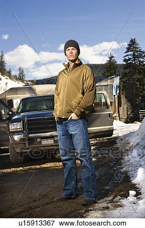 Man standing in front of truck View Large Photo Image Stock Photo - Man standing in front of truck . Fotosearch