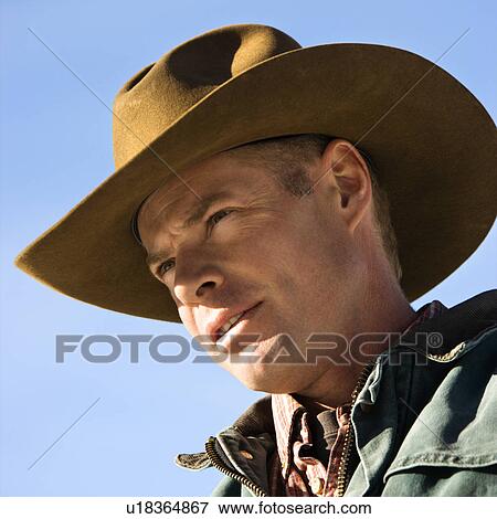 Man wearing a cowboy hat View Large Photo Image Stock Photo - Man wearing a cowboy hat. Fotosearch