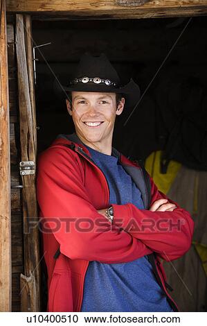 Stock Image - Man wearing cowboy hat. Fotosearch
