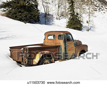Old rusted classic truck in snow covered field View Large Photo Image Stock Image - Old rusted classic truck in snow covered field. Fotosearch