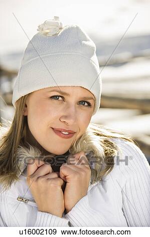 Stock Photo - Outdoors in winter wearing knit cap and coat . Fotosearch