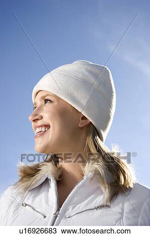 Portrait of a mid-adult female with blue sky in background. View Large Photo Image Stock Image - Portrait of a mid-adult female with blue sky in background.. Fotosearch