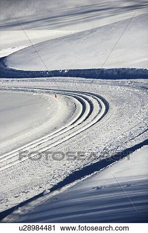 Snowmobile tracks winding through winter snow. View Large Photo Image Stock Image - Snowmobile tracks winding through winter snow.. Fotosearch
