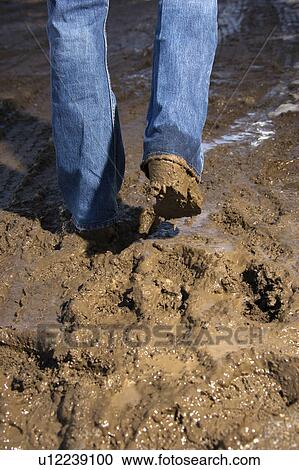 Walking in mud wearing jeans and boots View Large Photo Image Stock Image - Walking in mud wearing jeans and boots. Fotosearch