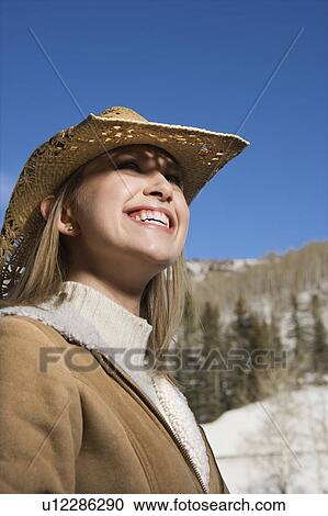 Woman in winter coat and straw hat looking up View Large Photo Image Stock Image - Woman in winter coat and straw hat looking up. Fotosearch