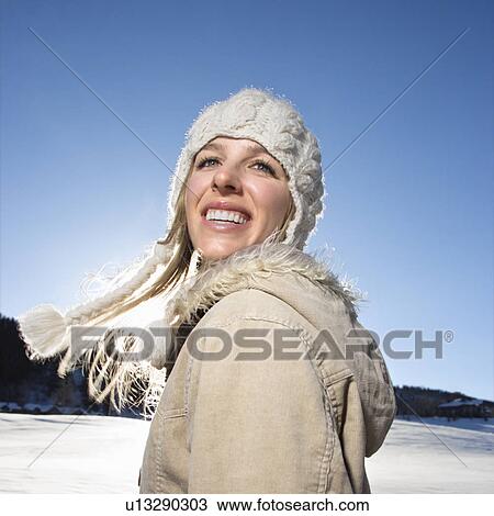 Stock Image - Woman outdoors in winter attire. Fotosearch