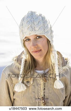 Stock Image - Young adult woman in winter attire looking at viewer.. Fotosearch