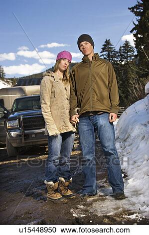 Stock Image - Young couple holding hands . Fotosearch