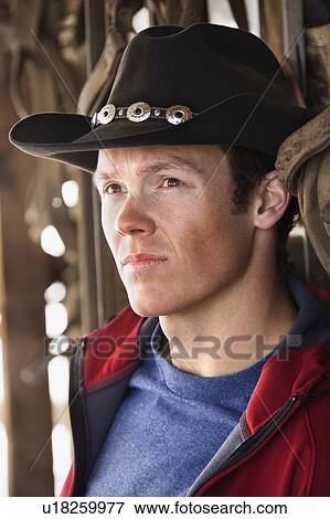 Young man wearing cowboy hat View Large Photo Image Stock Photo - Young man wearing cowboy hat. Fotosearch