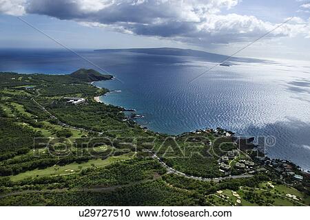 Aerial of coastline with Pacific ocean with island in background in Maui, Hawaii. View Large Photo Image Stock Image - Aerial of coastline with Pacific ocean with island in background in Maui, Hawaii.. Fotosearch