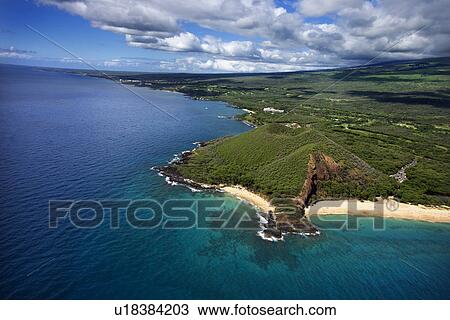 Stock Image - Aerial of Maui, Hawaii coastline with crater and cliffs and beach on Pacific ocean.. Fotosearch